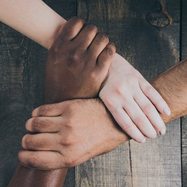 multi racial hands interlinked