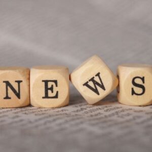 Four wood blocks with the letters N - E - W - S for a link to the Accents Newsletter.