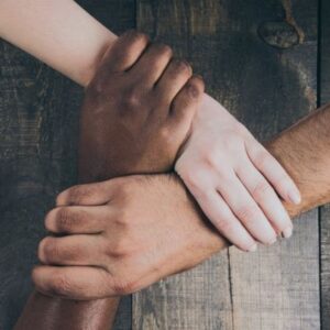 Three hands interlinked at the wrist, with different skin tones representing the variety of the fellowship and that we rely on being connected.